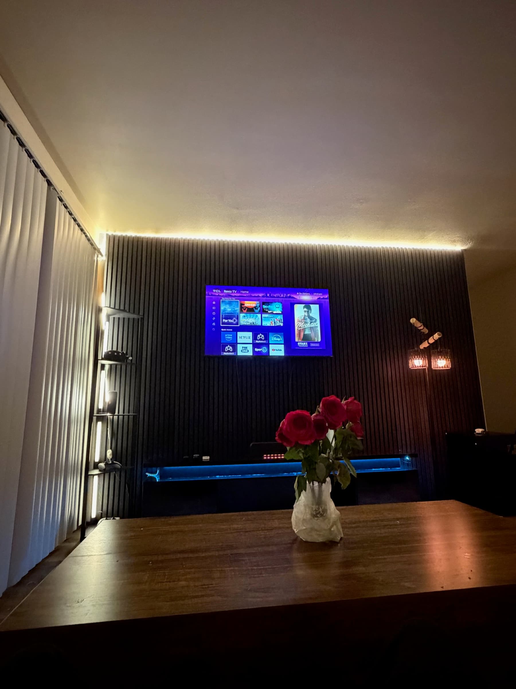 Finished slat-panel media wall with perimeter accent lighting, Denver Front Range